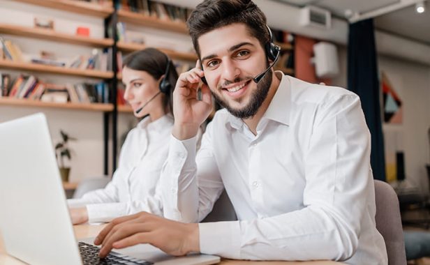 man-works-as-call-center-support-operator-with-headset-typing-laptop